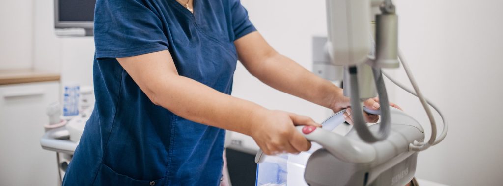 Female doctor working on ultrasound scanning machine