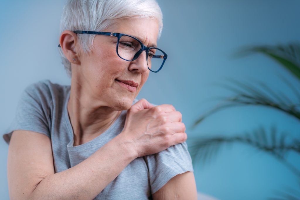 Frozen Shoulder. Senior Woman Holding Cold Compress, Ice Bag Pack on her Painful Shoulder